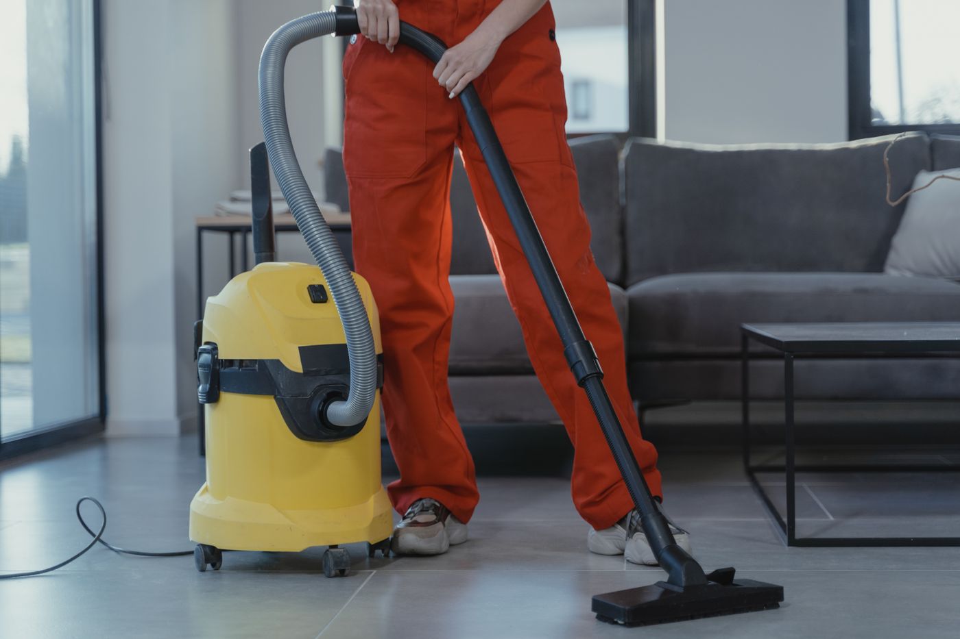 Professional commercial cleaner vacuuming a modern office floor