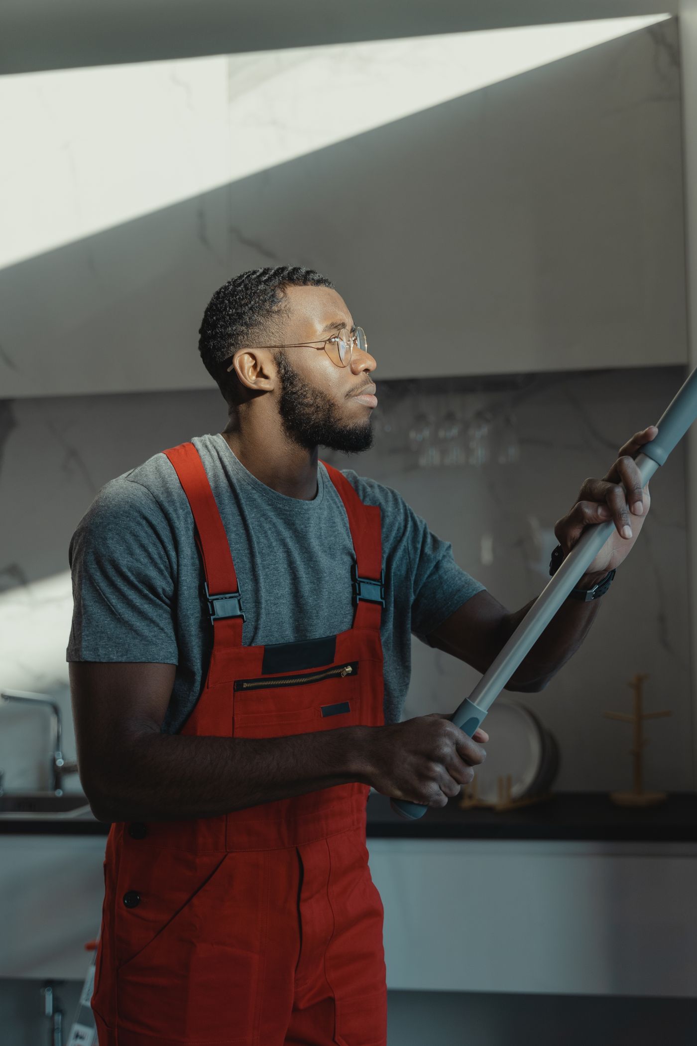 Professional janitor in uniform ready for commercial cleaning service